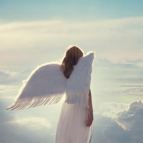 Female angel with wings floating among the clouds